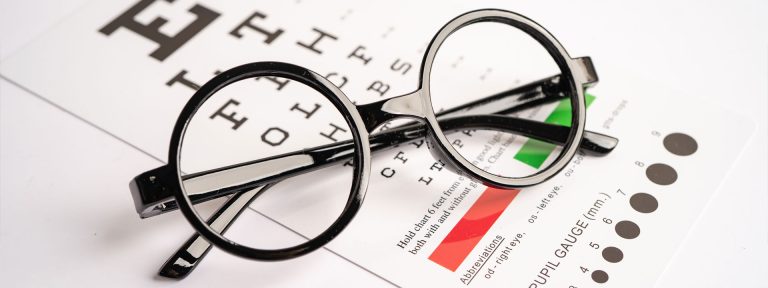 Spectacle frames on top of an eye chart